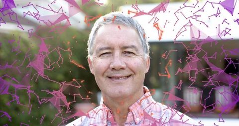 Smiling senior man standing on porch with vibrant magenta-purple particle network overlay