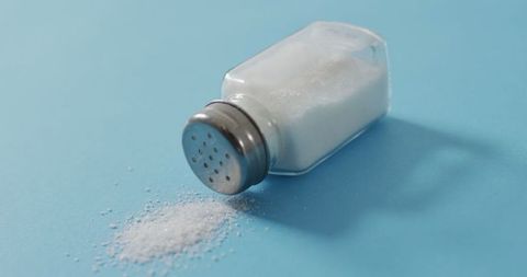 Salt Shaker on Blue Background with Spilled Salt - Download Free Stock Images Pikwizard.com