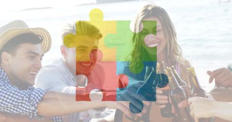 Friends toasting with beer on sunny beach with colorful jigsaw overlay