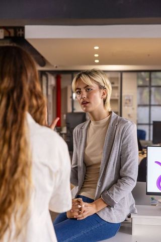 Female professionals collaborating in open-plan office space