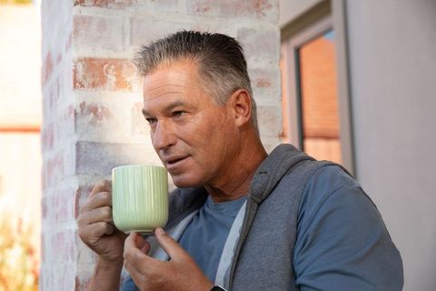 Mature Man Contemplating with Coffee Outdoors