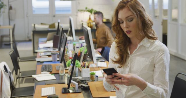 Businesswoman Checking Smartphone in Modern Office Workspace - Download Free Stock Images Pikwizard.com