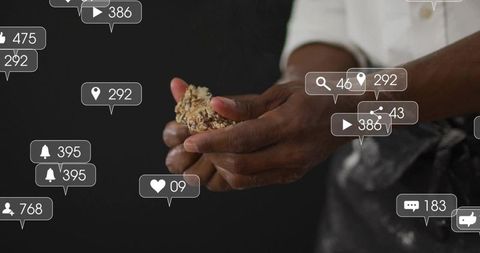 Pressing artisan granola cluster with hands and social media notification overlays