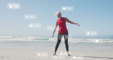 Woman Engaging in Social Media Interaction While Exercising on a Beach