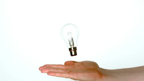 Creative Concept of Floating Light Bulb Above Hand