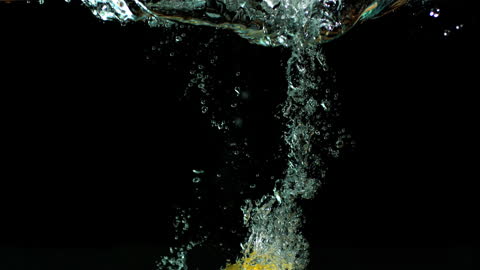 Lemons Splashing Underwater in Slow Motion