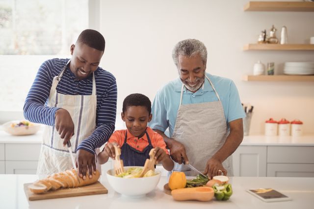 Happy multi-generation family preparing food in kitchen at home