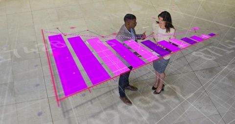 Business colleagues discussing holographic magenta bar chart in modern tiled atrium
