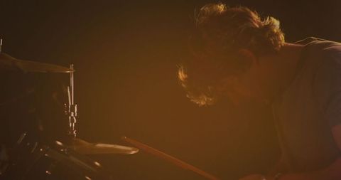 Caucasian Male Drummer Performing Under Orange Stage Lights - Download Free Stock Images Pikwizard.com
