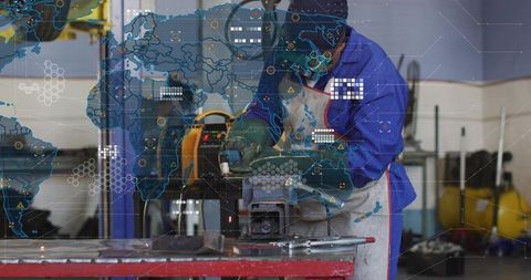 Industrial Welder Grinding Metal on Bench Vise with Protective Helmet and HUD