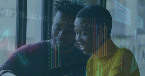 Business professionals analyzing data with digital charts in modern office