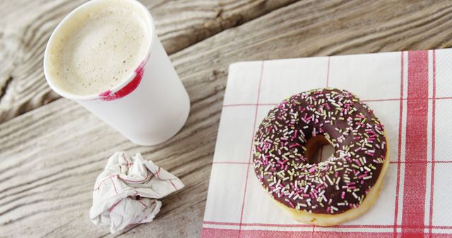 Coffee and Donut with Chocolate Icing and Sprinkles on Wooden Table - Download Free Stock Images Pikwizard.com