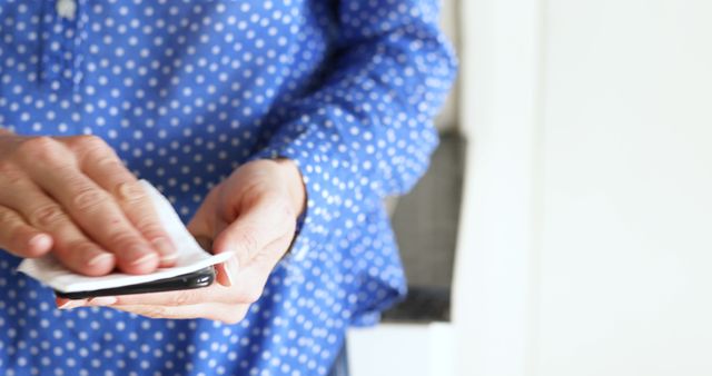 Person Cleaning Smartphone with Disinfecting Wipe - Download Free Stock Images Pikwizard.com