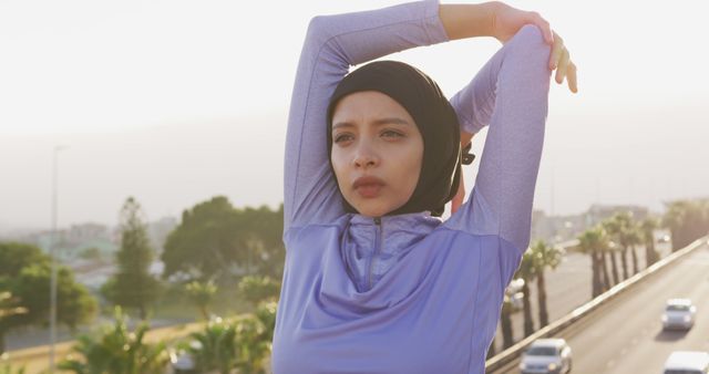 Young Muslim Woman Stretching in Outdoor Urban Setting - Download Free Stock Images Pikwizard.com