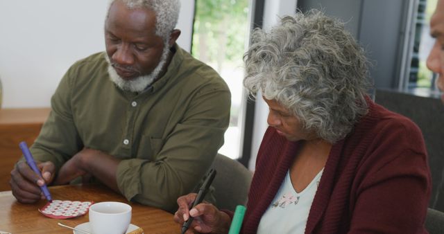 Senior Couple Engaging in Activity with Notes at Home - Download Free Stock Images Pikwizard.com