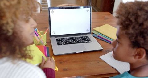 Mother and Son Bonding with Laptop at Home