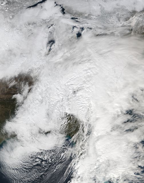 Satellite imagery showing extensive cloud cover from a large low pressure area stretching from New England to Florida. Useful for weather forecast visuals, climate study materials, and educational content on atmospheric science.