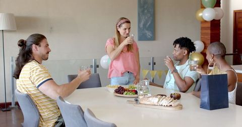Friends Enjoying Drinks and Snacks During Social Gathering