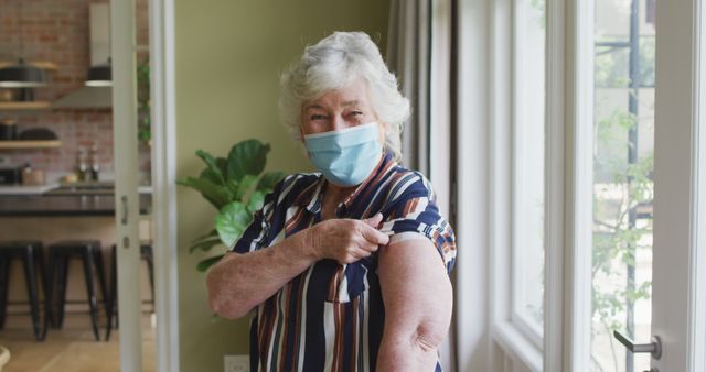 Senior Woman Showing Vaccinated Arm While Wearing Mask Indoors - Download Free Stock Images Pikwizard.com