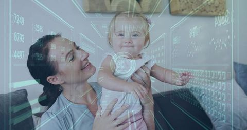 Mother holding smiling baby with futuristic hud overlay on sofa, augmented home data concept