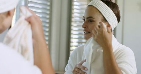 Woman Performing Skincare Routine in Relaxing Home Bathroom