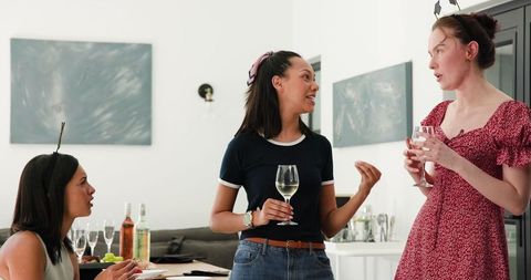 Diverse Female Graduates Celebrating Friendship with Wine