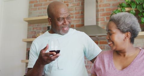 Senior Couple Enjoying Wine in Cozy Kitchen