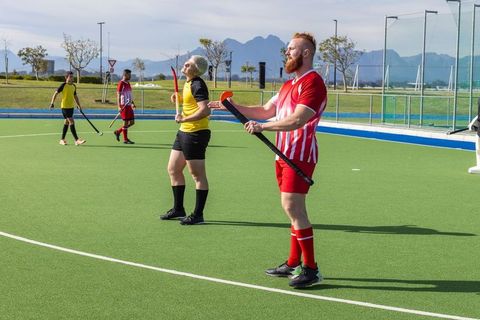 Field Hockey Players on Turf Ready for Action