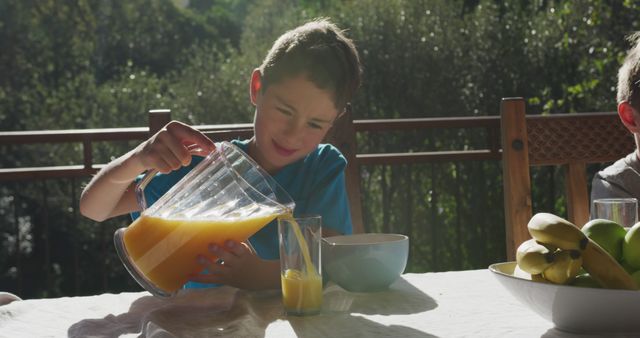 Boy Pouring Orange Juice for Breakfast on Sunny Morning - Download Free Stock Images Pikwizard.com