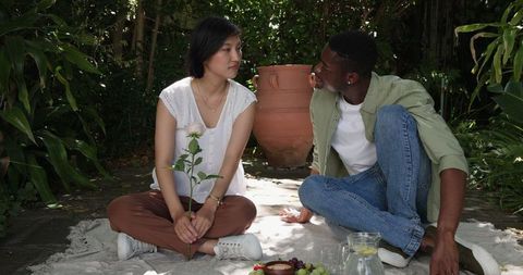 Couple Preparing Wedding Ceremony Florals in Garden
