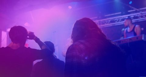 Crowd Enjoying Live Band Performance in Vibrant Nightclub Atmosphere
