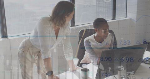 Coworkers Collaborating on Financial Data in Modern Office
