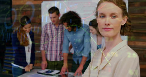 Diverse Business Team Analyzing Data with Overlayed Graphs