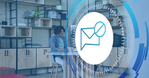 Young woman working at boutique studio desk with virtual message HUD overlay