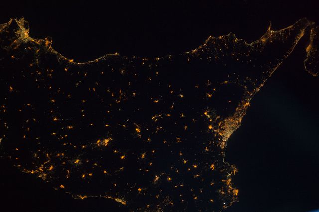 ISS040-E-087275 (1 Aug. 2014) --- Much of the Italian island/province of Sicily is visible in this nighttime nadir image photographed from 221 nautical miles above Earth by one of the Expedition 40 crew members aboard the International Space Station. The tip of the "toe" of Italy's "boot" is barely visible in the upper right corner.