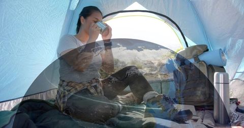 Woman Enjoying Morning Coffee in Camping Tent Amidst Nature