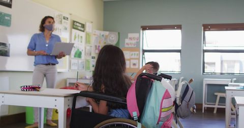 Teacher in Mask Leading Classroom with Students During Pandemic