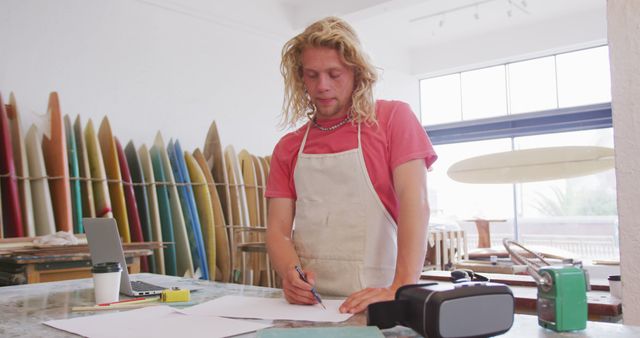 Blonde Artisan Designing Surfboards in Workshop - Download Free Stock Images Pikwizard.com