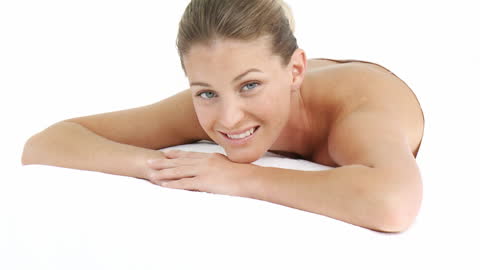 Young Woman Smiling While Relaxing at Spa