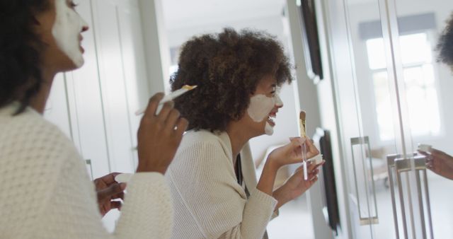 Women relax together at home, applying face masks and enjoying a skincare routine. Ideal for representing beauty, friendship, home spa day, self-care tips, and lifestyle blogs.