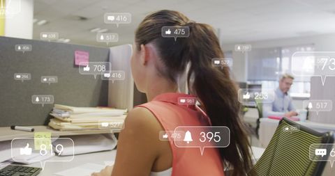 Businesswoman Managing Social Media Engagement in Modern Office