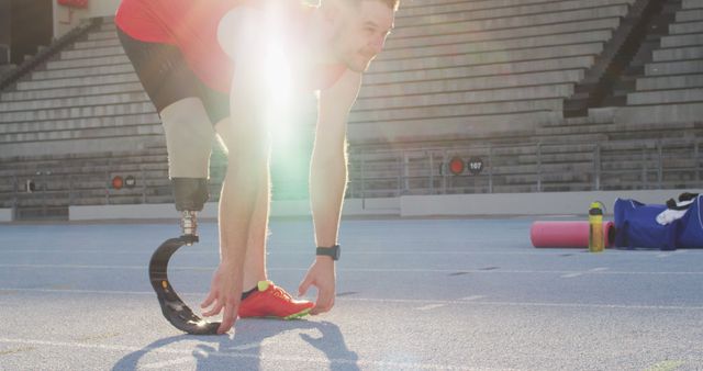 Athlete with Prosthetic Leg Preparing for Runner’s Starting Position on Track - Download Free Stock Images Pikwizard.com