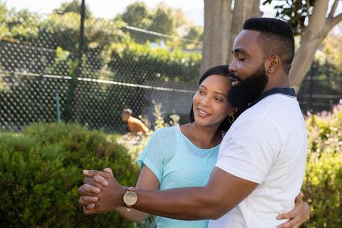 Diverse Couple Dancing in Sunlit Garden