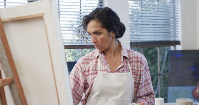 Focused Female Artist Painting on Canvas in Studio - Download Free Stock Images Pikwizard.com