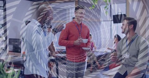 Colleagues holding coffee and networking in open-plan office with circular overlay