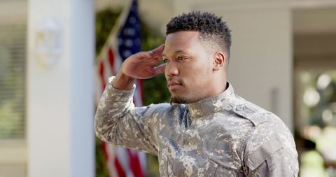 Proud African American Soldier Saluting USA Flag at Home
