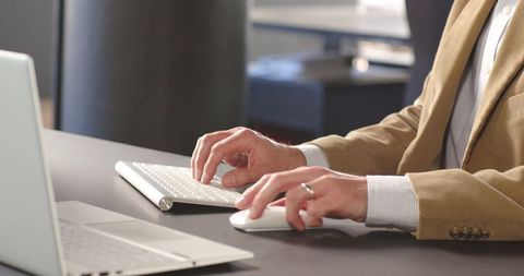 Business professional using wireless keyboard at office