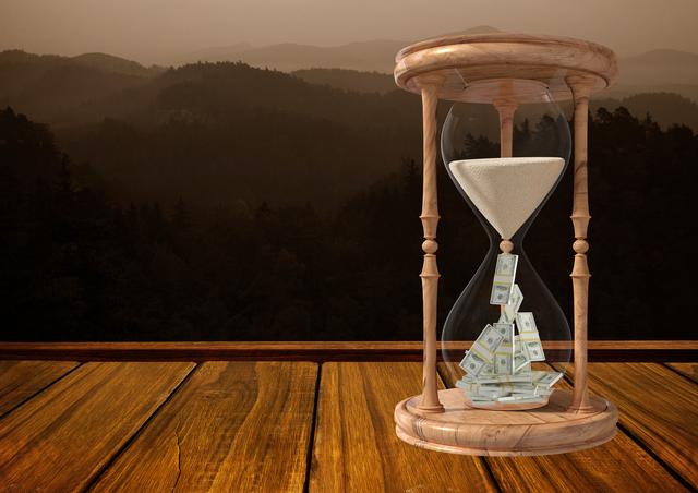 Digital composite conceptual image of dollars and sand in hourglass kept on wooden plank