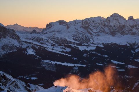 Alpine Peaks Glowing at Sunrise with Orange Snow Mist and Powdered Ridge
