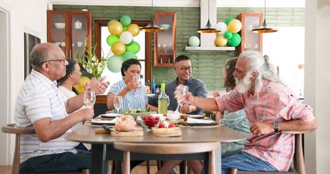 Senior Friends Enjoy Dinner Party and Celebration Toast